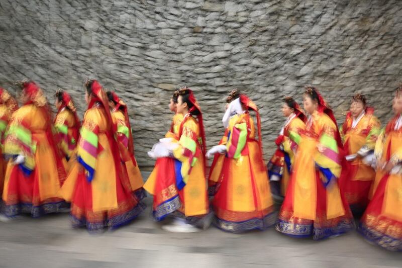 Students wearing the traditional South Korean costume of ‘hanbok’ attend a re-enactment of the royal wedding ceremony of King Sunjong and Queen Sunjeonghyou during the Jongno Hanbok Festival in Seoul, South Korea, on September 23, 2016. Jeon Heon-Kyun / EPA