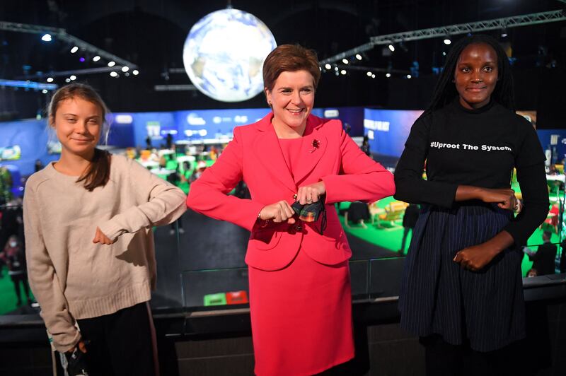 Scotland's First Minister Nicola Sturgeon (C) poses for a photograph as she meets climate activists Vanessa Nakate (R) and Greta Thunberg. AFP
