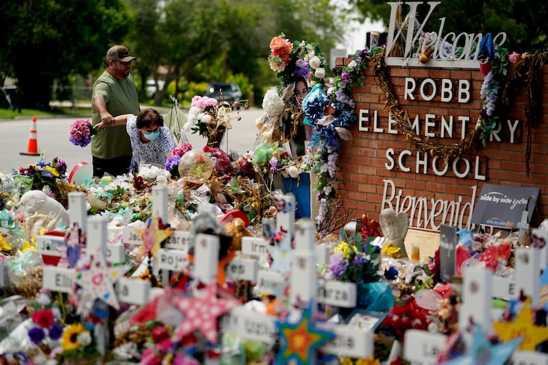 Retired teachers visit a memorial honouring the school shooting victims. AP