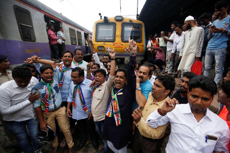 Supporters of Maharashtra Navnirman Sena (MNS) party shout slogans as they block a railway track during a protest against record high petrol and diesel prices in Mumbai, India September 10, 2018. REUTERS/Francis Mascarenhas