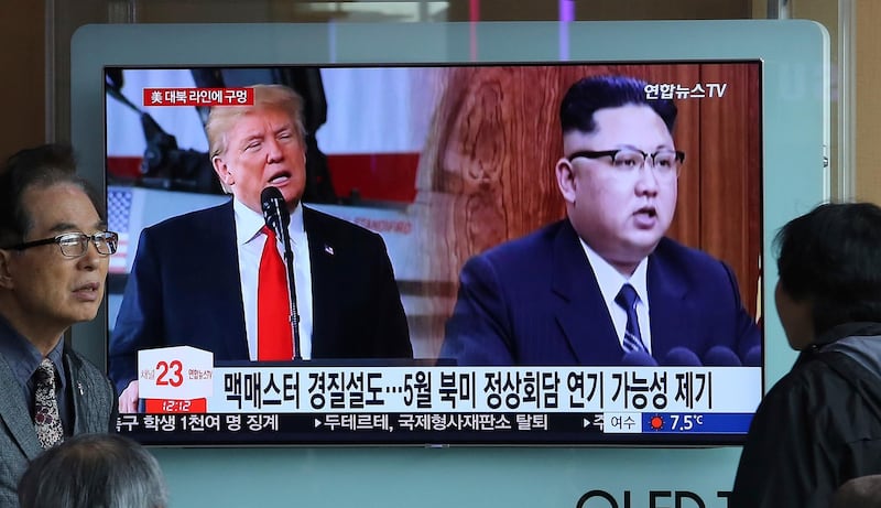 A TV screen shows North Korean leader Kim Jong Un, right, and U.S. President Donald Trump during a news program at the Seoul Railway Station in Seoul, South Korea, Saturday, March 17, 2018. President Donald Trump and South Korean President Moon Jae-in, who are both planning to meet North Korea's leader Kim Jong Un this spring, pledged Friday to maintain "maximum pressure" on his authoritarian regime and seek action on giving up his nukes, the White House said. The signs read: " The possibility of delaying the summit between the United States and North Korea in May." (AP Photo/Ahn Young-joon)