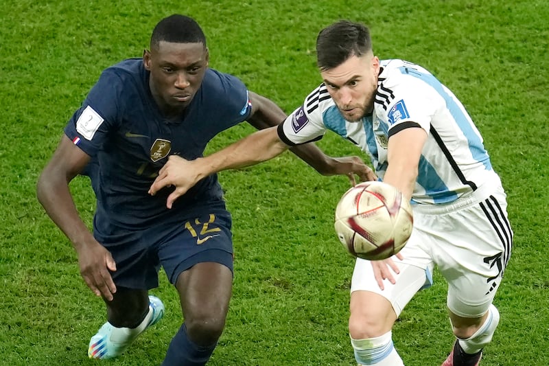 Argentina's Nicolas Tagliafico and Randal Kolo Muani fight for the ball. AP