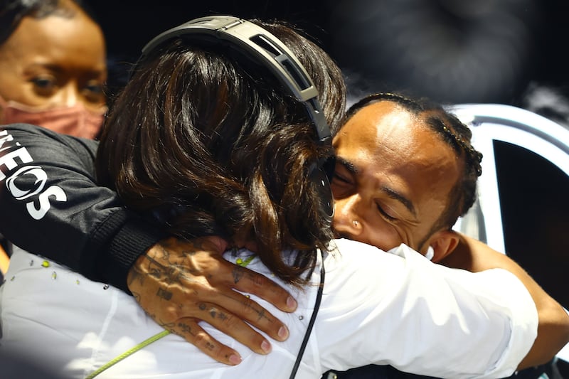 Lewis Hamilton hugs Michelle Obama at the Miami International Autodrome. AFP
