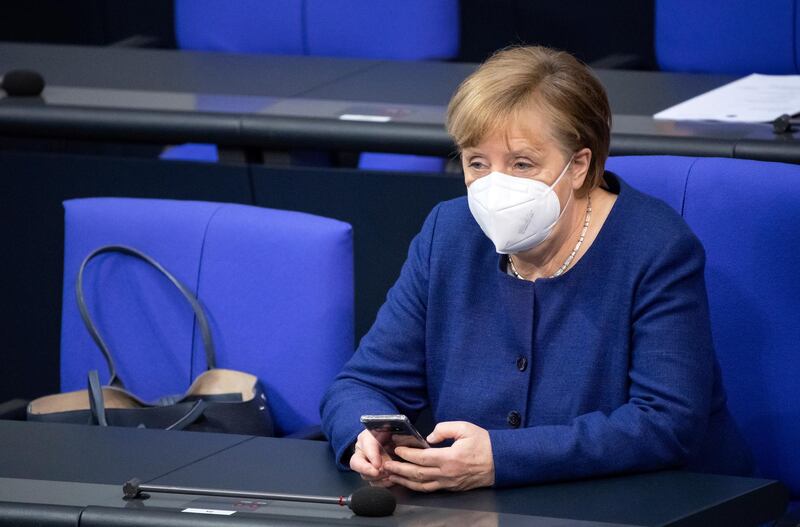 German Chancellor Angela Merkel wears a face mask as she attends a session of German parliament Bundestag in Berlin. AP Photo