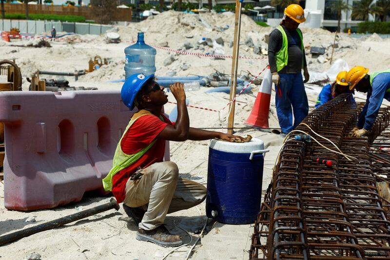 A worker drinks water on a construction site in Dubai. Many jobs are adaptable, and a great deal of building and roadworks take place after sunset during the summer, reducing the harm posed by high temperatures and sun exposure. Reuters