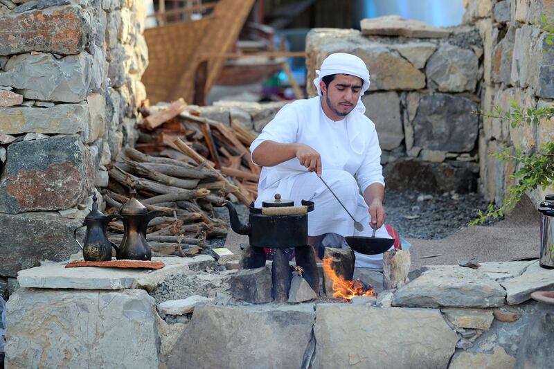 Sharjah, United Arab Emirates - Reporter: Razmig Bedirian. Arts. A man makes coffee and food in the mountain environment at the Heart of Sharjah for Sharjah Heritage Days. Monday, March 22nd, 2021. Sharjah. Chris Whiteoak / The National