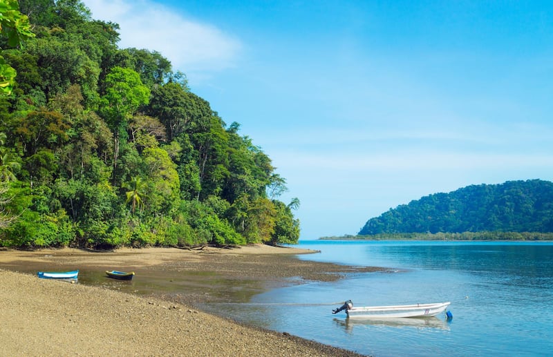 View of Playa Cacao ( Cacao Beach), sand, boats, water and rainforest. Golfito, Costa Rica. Getty Images