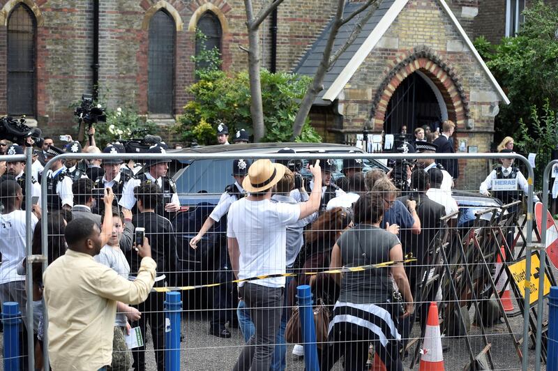 FILE PHOTO: Police officers protect the entourage carrying Britain's Prime Minister Theresa May from a crowd of people after she visited a church following the fire that destroyed The Grenfell Tower block, in north Kensington, West London, Britain June 16, 2017. REUTERS/Hannah McKay/File Photo