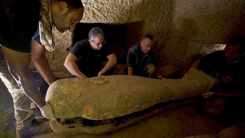 Secretary General of the Supreme Council of Antiquities Mostafa Waziri inspecting one of the 2,500-year-old wooden coffins discovered in a burial shaft at the desert necropolis of Saqqara south of Cairo. AFP