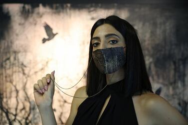 A model wearing a face mask made in Jordan using eggplant skin, in Amman, June 17, 2020. Reuters