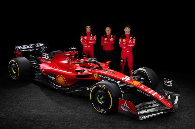 Ferrari driver Carlos Sainz Jr, team principal Frederic Vasseur, and driver Charles Leclerc with the team's new SF-23 car for the 2023 season at Maranello. AFP