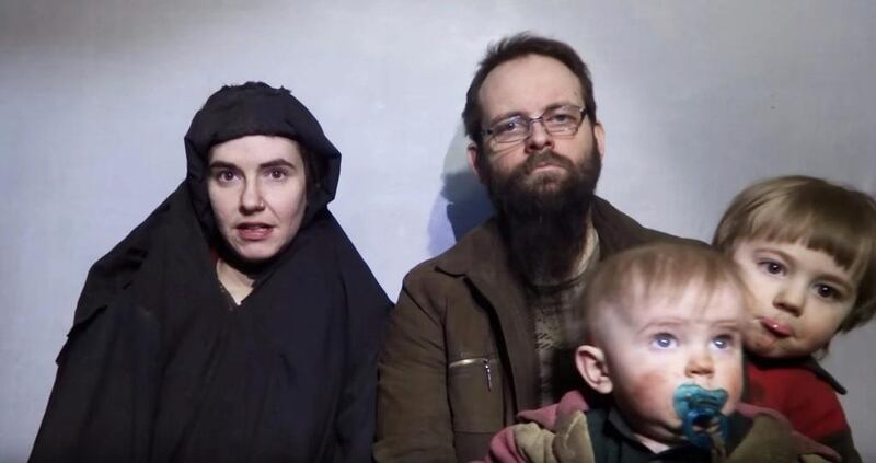 A still image from a video posted by the Taliban on social media on December 19, 2016 shows American Caitlan Coleman, left, speaking next to her Canadian husband, Joshua Boyle, and their two sons who were born in captivity. Taliban / Social media via Reuters