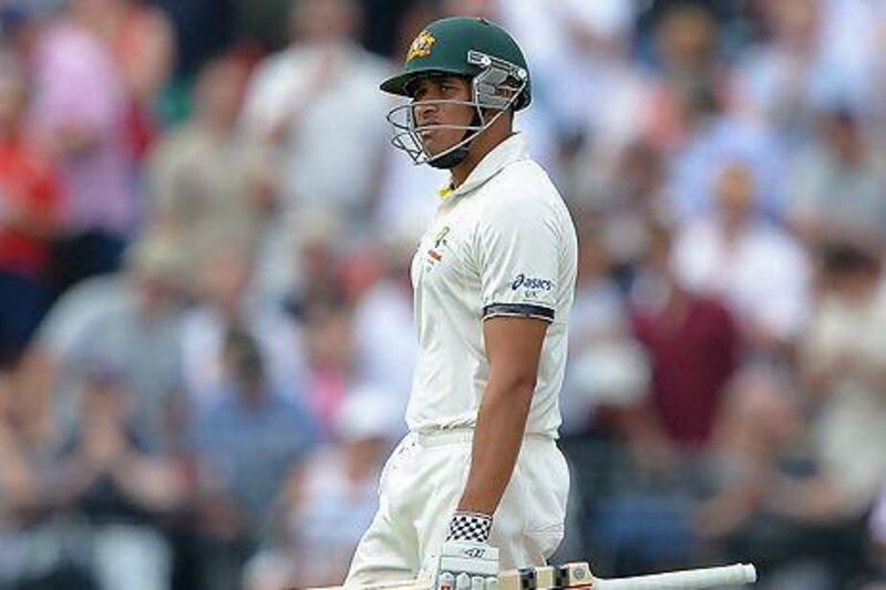 Australia's Usman Khawaja walks off after being given out during play on the first day of the third Ashes Test at Old Trafford. Andrew Yates / AFP