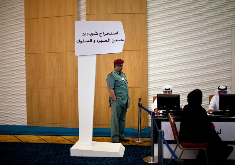 As a police officer keeps a carfeful watch, candidates register to stand in the Federal National Council election on Wednesday, August 17, 2011, the last day of registration at the Abu Dhabi National Exhibition Center in Abu Dhabi. The previous three days brought in 71 people. (Silvia Razgova/The National)

