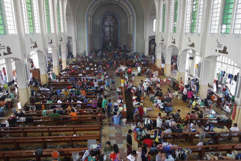 Filipinos seek refuge inside a Catholic church converted into an evacuation centre after typhoon Haiyan battered Tacloban city. Romeo Ranoco / Reuters