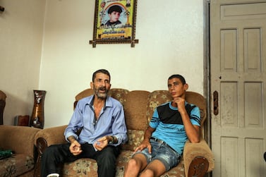 Ahed Bakr sits with Montaser Baker, his 17-year-old son, in his home in Gaza City. Majed Mahmoud for The National