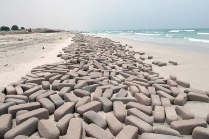 Relevant authorities in Umm Al Quwain said that the large quantities of bricks that appeared all of a sudden along the emirateÕs seashore washed up when a foreign freight ship that was transporting them on its way to Iraq sank at eight nautical miles off Dubai shore.
Dubai PoliceÕs marine patrols were able to rescue the shipÕs seven-man crew, whereas the ship sank along with its 1500-tonne building materials cargo.
The ship sank almost one week ago due to overload. High winds caused it to topple over and sink.
The Ministry of Environment and Water, in coordination and cooperation with the relevant authorities in UAQ, followed up on the sudden accumulation of building materials on the emirateÕs shores and carried out all the necessary tests to rule out environmental pollution or contamination. The department of works and services already began to remove the bricks and clean out the seashore. (Photo Courtesy-Al Ittihad)