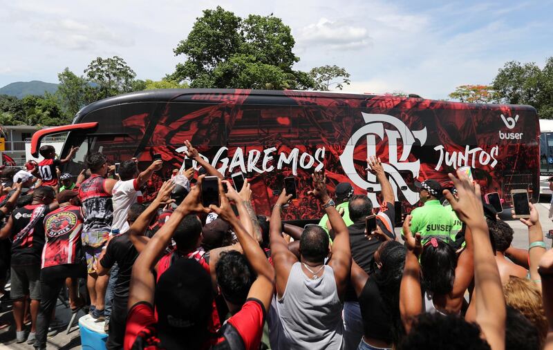 Flamengo supporters alongside the team bus outside their training centre. Reuters