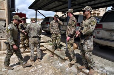 US soldiers attend the handover ceremony of the US-led coalition forces base inside the complex of the former presidential palace in Mosul, northern Iraq on 30 March 2020. EPA