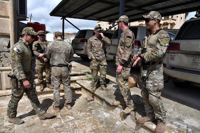 epa08332141 US soldiers attend the handover ceremony of the US-led coalition forces base inside the complex of the former presidential palace in Mosul, northern Iraq on 30 March 2020. According to local source, the US-led coalition forces withdrew from the fourth military bases in northern Iraq, amid heightened tensions with Iran-backed Iraqi shiite armed groups in Iraq.  EPA/AMMAR SALIH  EPA-EFE/AMMAR SALIH