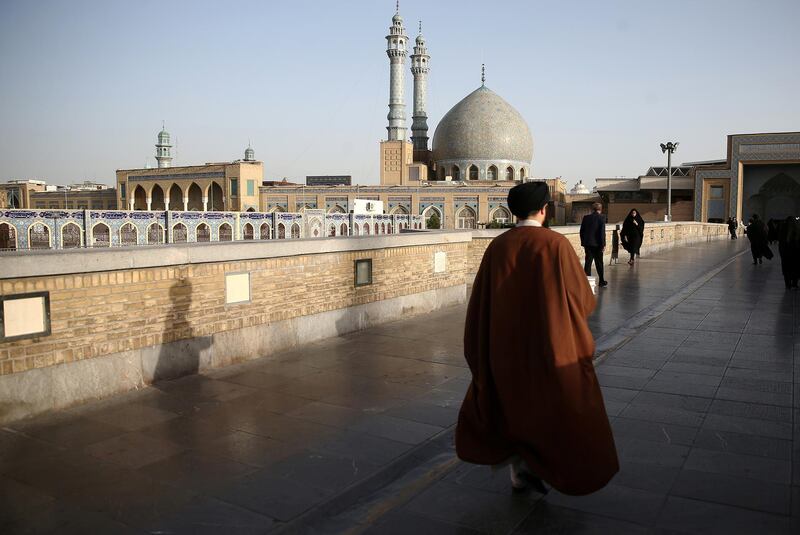 FILE PHOTO: An Iranian cleric walks in front of the Shrine of Fatima Masumeh in Qom, Iran February 09, 2020. Nazanin Tabatabaee/WANA (West Asia News Agency) via REUTERS/File Photo