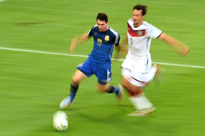 Messi runs past Mats Hummels as both players match each other for speed. Christophe Simon / AFP