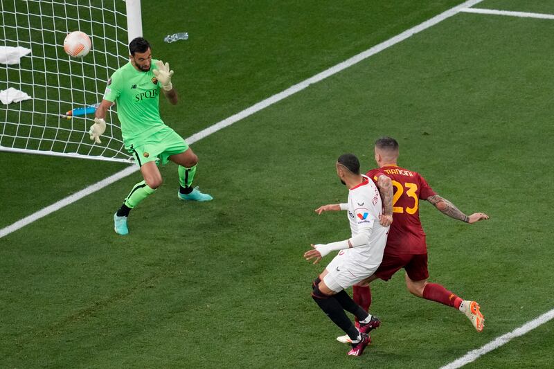 Roma's Gianluca Mancini, right, scores an own goal to level the scores. AP 