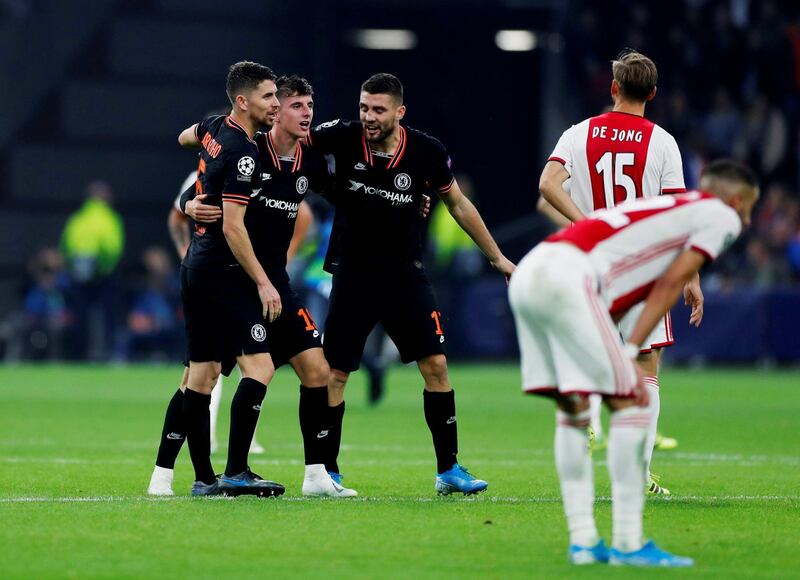 Mason Mount celebrates with Jorginho and Mateo Kovacic after the match in Amsterdam. Reuters