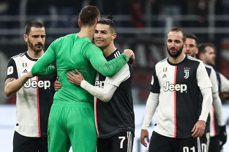 Cristiano Ronaldo embraces AC Milan goalkeeper Gianluigi Donnarumma after the match. AFP