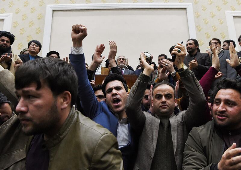 People cheer as Afghan presidential election opposition candidate Abdullah Abdullah (C) gives a press conference after the announcement of the final presidential elections results at the Sapedar Palace in Kabul on February 18, 2020. Afghan presidential election loser Abdullah Abdullah on February 18 contested final results that declared his rival Ashraf Ghani the winner of last year's poll, vowing he would form his own parallel government. Afghan election officials said final results showed he had won 39.52 percent of last September's vote, while Ghani had taken 50.64 percent. / AFP / WAKIL KOHSAR
