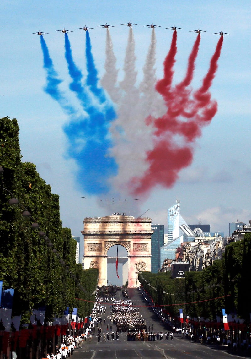 Alpha jets from the French Air Force Patrouille de France fly over the Champs-Elysees. Gonzalo Fuentes / Reuters