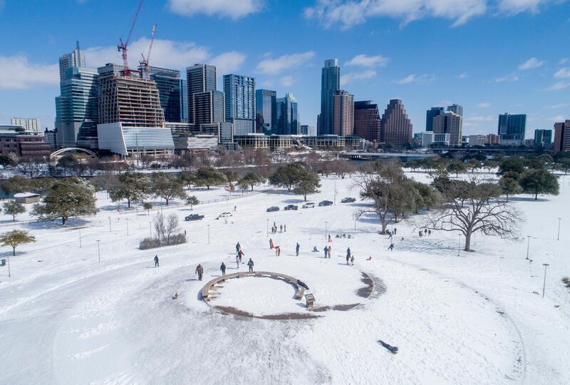 People play in the snow in Butler Park in Austin. AP