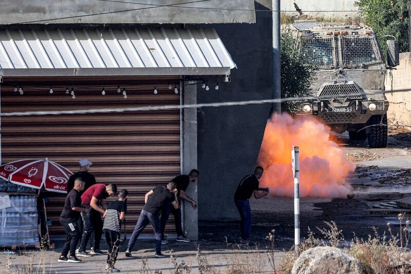 An explosive charge left by Palestinians detonates in front of an Israeli armoured vehicle during the Jenin raid. AFP