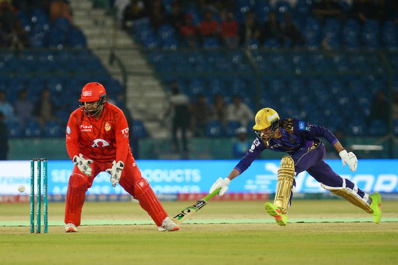 Islamabad United's Azam Khan, left, tries to run out Quetta Gladiators' Muhammad Wasim during their Pakistan Super League match at the National Cricket Stadium in Karachi on Friday, March 15, 2024. EPA