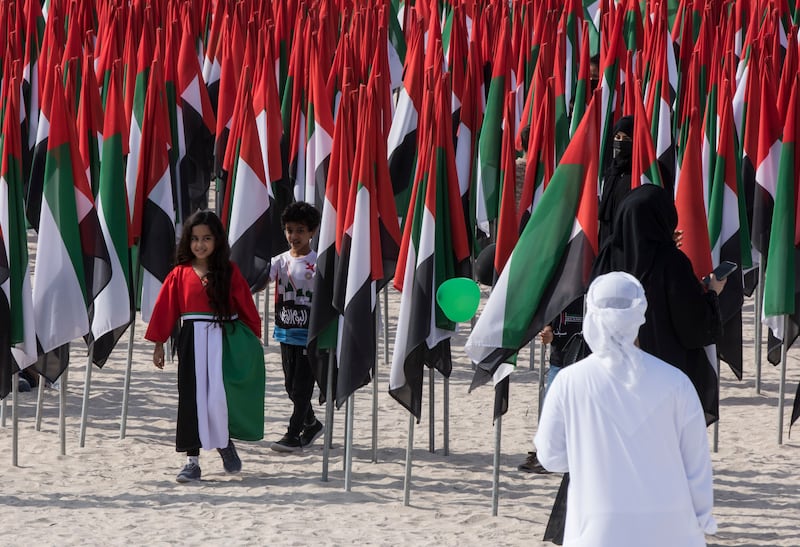 A girl and a boy with UAE flag colours at Kite Beach, on Jumeirah Beach Road.  Ruel Pableo / The National