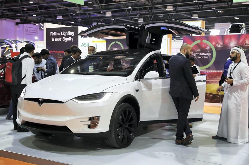 DUBAI , UNITED ARAB EMIRATES ,  October 23 , 2018 :- Visitors looking at the Tesla Model X car at the Tesla stand during the WETEX 2018 held at Dubai World Trade Centre in Dubai. ( Pawan Singh / The National )  For News/Business. Story by Patrick/ Jennifer