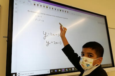 DUBAI, UNITED ARAB EMIRATES , March 9, 2021 –  Alex George solving the maths question at the Hartland International School in Dubai. Alex George, an 11-year-old pupil scored a 9 in IGCSE Mathematics. This is the highest score possible. Usually, children in year 11 (aged 15-16) sit for this exam, but Alex appeared for it four years in advance. Alex is in an accelerated programme at Hartland International School in Dubai. (Pawan Singh / The National) For News/Online. Story by Anam