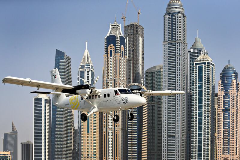 Dubai, September 2, 2013 - Focal point - A Skydive Dubai plane prepares for landing in front of a graphic, stripey skyline in Dubai, September 2, 2013. (Photo by: Sarah Dea/The National, Story by: N/A) *** Local Caption ***  SDEA010913-focalpoint17.JPG