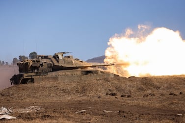 An Israeli tank fires a round during a drill in the annexed Golan Heights on November 9, 2023, amid increasing cross-border tensions between Hezbollah and Israel as fighting continues in the south with Hamas militants in the Gaza Strip. (Photo by Jalaa MAREY / AFP)