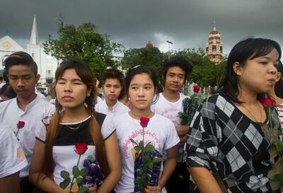 Protesters holding roses attend a protest in front of city hall in Yangon, Myanmar, Sunday Sept. 3, 2017. Myanmar activists took part in a protest Sunday, praying for victims killed during conflict and condemning the attacks carried out in Rakhine state, western Myanmar. (AP Photo)