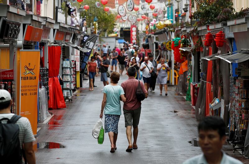 Pedestrians pass through Singapore's Chinatown. Reuters