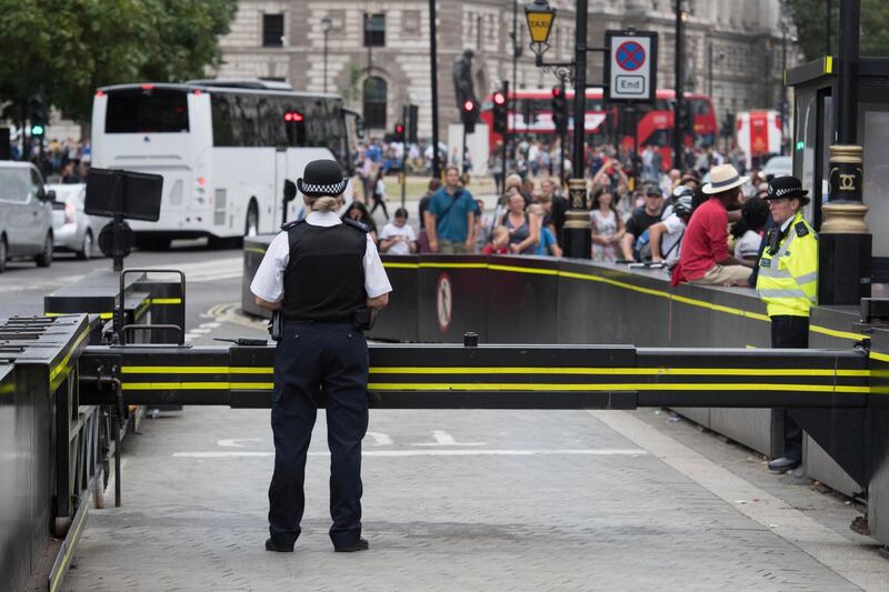 The area is packed with tourists as police secure the scene near a road barrier outside the Houses of Parliament in London, the day after a suspected terror attack, Wednesday Aug. 15, 2018. British counter-terrorism police are carrying out investigations after a car slammed into barriers outside the Houses of Parliament in London on Tuesday.(Stefan Rousseau/PA via AP)
