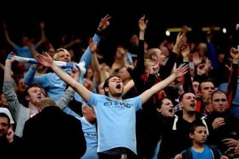 Manchester City fans, left, and United supporters, right, agree the rivalry has changed for the better with City's emergence as title contenders. Laurence Griffiths / Getty Images; Dave Thompson / PA