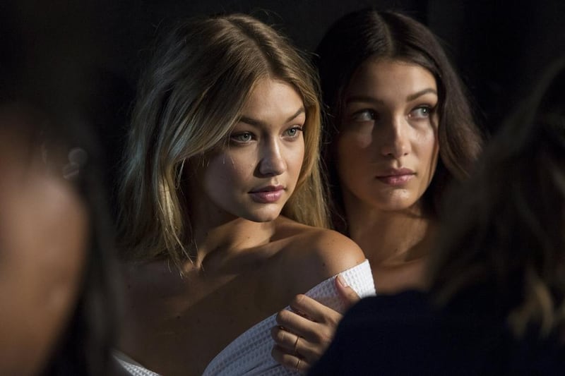 Models Gigi Hadid, left, and Bella Hadid pose for photos backstage before the Tommy Hilfiger Spring/Summer 2016 collection presentation during New York Fashion Week. Andrew Kelly / Reuters