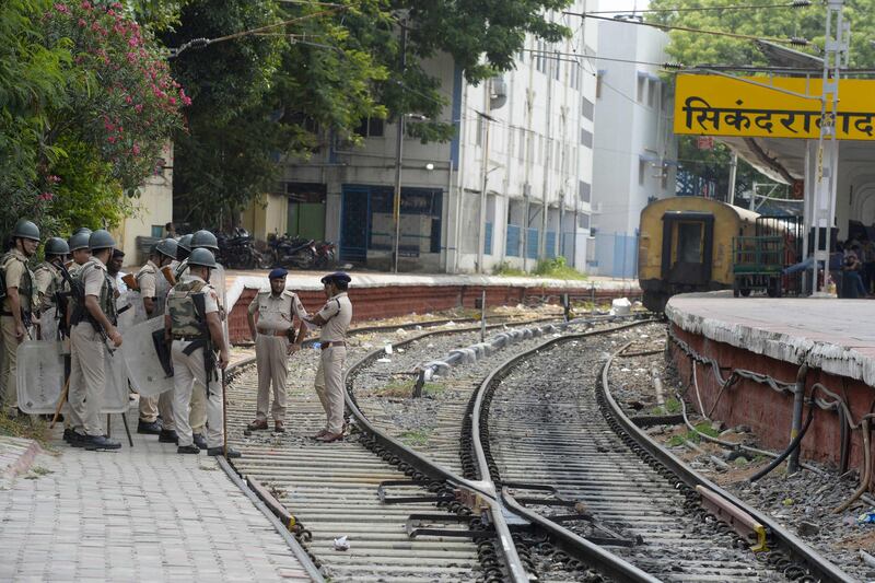 Railway Protection Force personnel stand guard. 