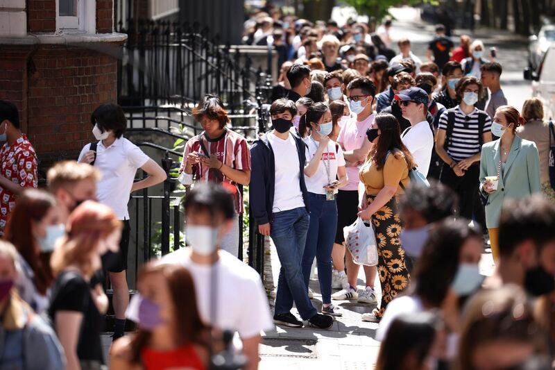 People queue outside a vaccination centre for young people and students at the Hunter Street Health Centre in London. Reuters