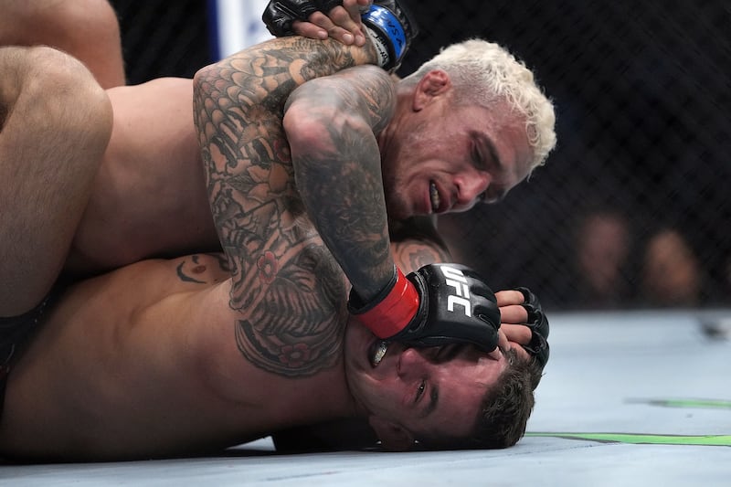 Charles Oliveira pins Dustin Poirier to the mat. Reuters