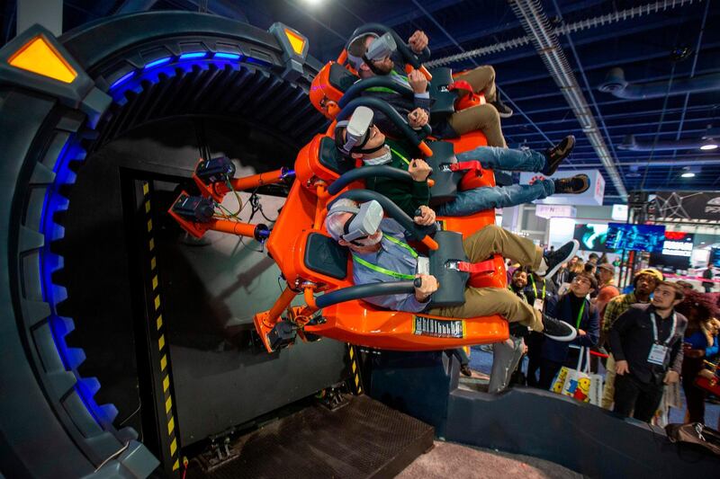 Attendees try the DOF Robotics Hurricane 360 VR ride. AFP
