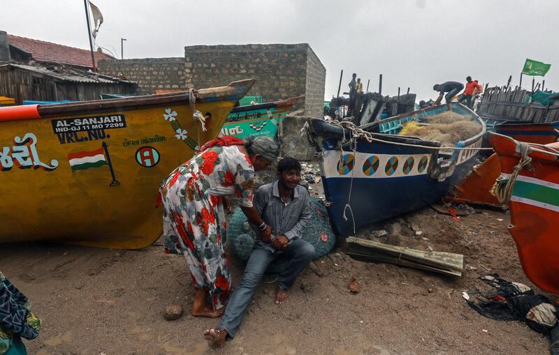 A fisherman cries as he got injured while moving his boat to a safer place along the Arabian sea coast, as the Cyclone Vayu approaches Veraval, India.  EPA