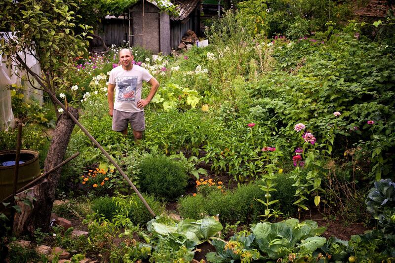 Igor Norenko, Leninsky District, Donetsk. 
I made different levels of the garden for different types of plants and find it’s more economical for watering. About 80 percent of it is for the family to eat - the only things I don’t grow are potatoes and onions. The plant where I work is closed while this war carries on so I’ve got more time to garden. I love this garden, and have lived here all my life. No matter what time of year it is, this garden is wonderful. In the winter my children sledge down the hill on the snow! The war is a real mess, i don’t blame anyone - both sides have made mistakes. I never thought I’d see war in my lifetime. The city is almost empty now - even my family  left Donetsk when the shelling started r. My wife begged me to go with her but I couldn’t leave this house or this garden. I’ve lived here all my life; this is my garden and this is my home. 